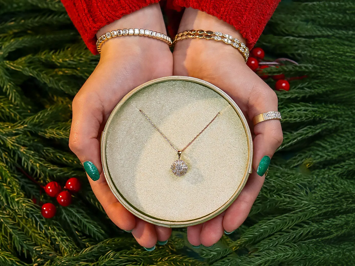 Hands holding a green jewelry box with a Diamond necklace.