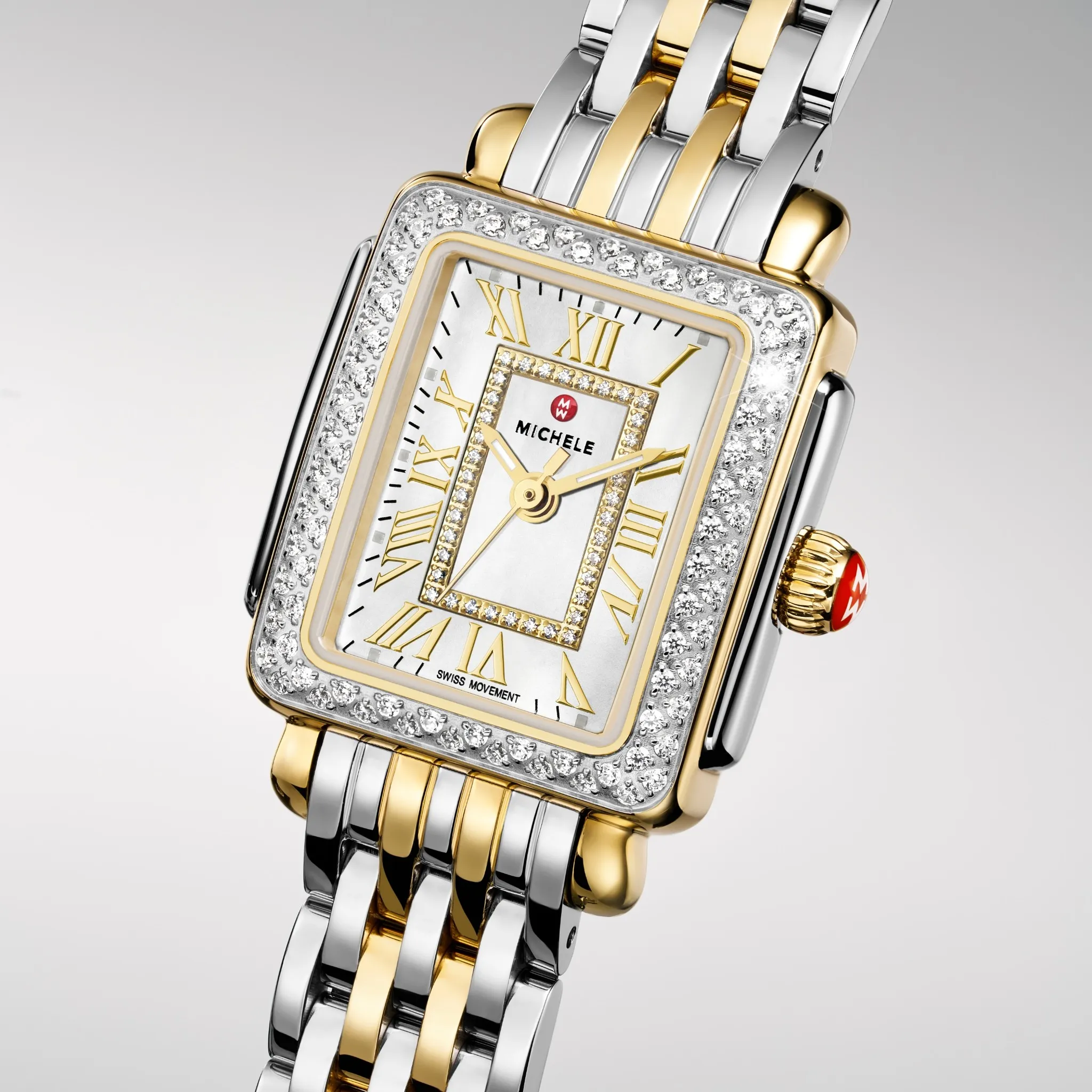 Woman wearing a luxury watch with a gold and silver band, seated on a blue chair.