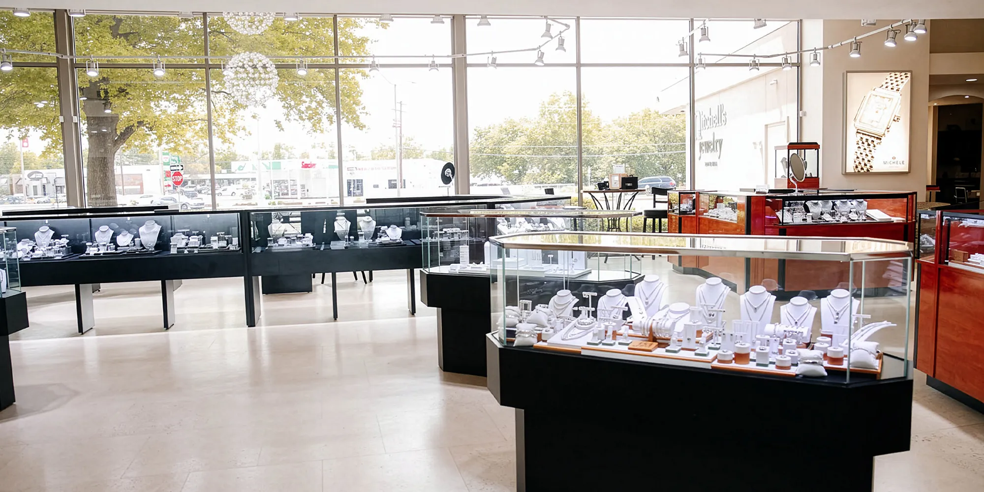Interior of Mitchell's Jewelry store with glass display cases showcasing various jewelry pieces.