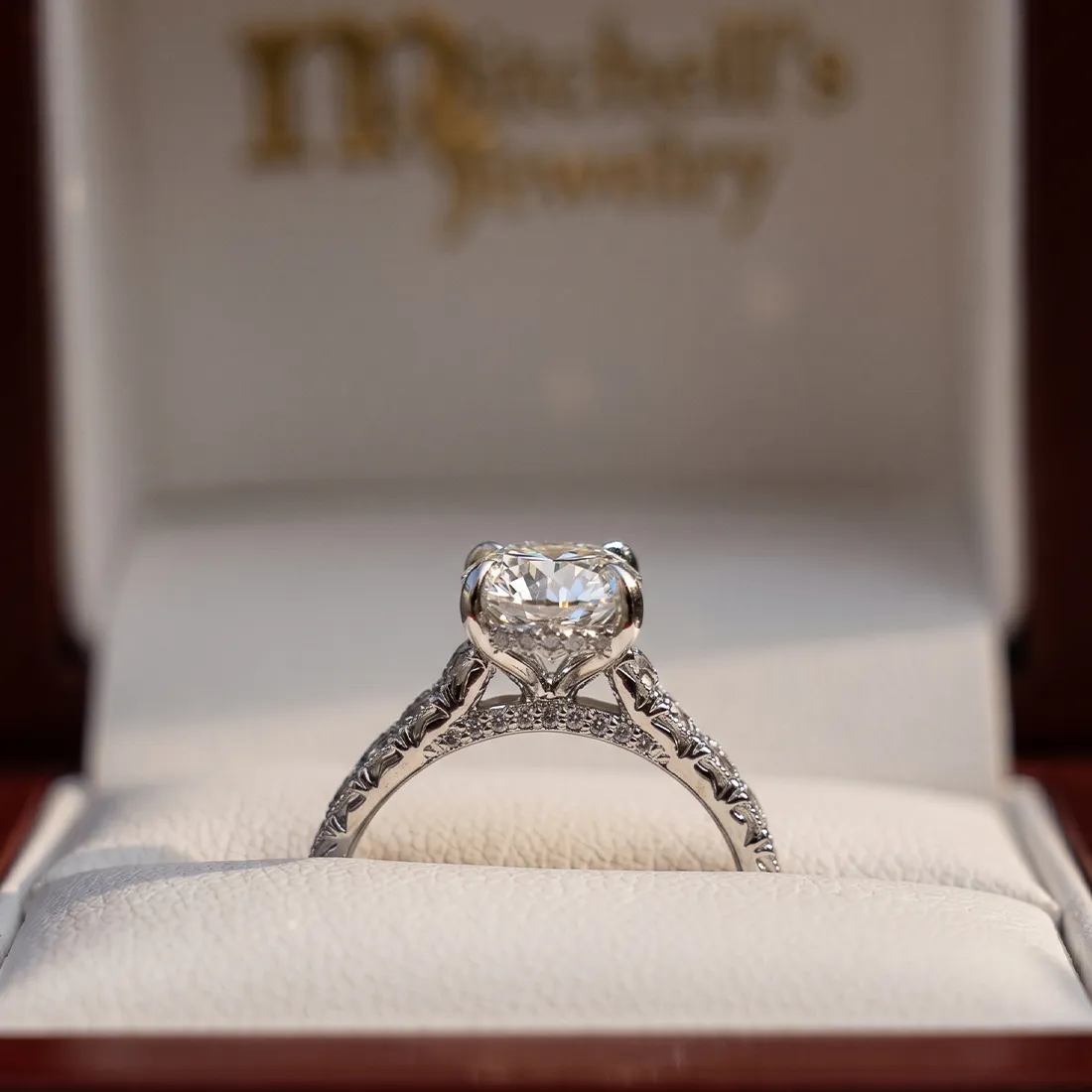 Elegant diamond engagement ring in a Mitchell's Jewelry box.