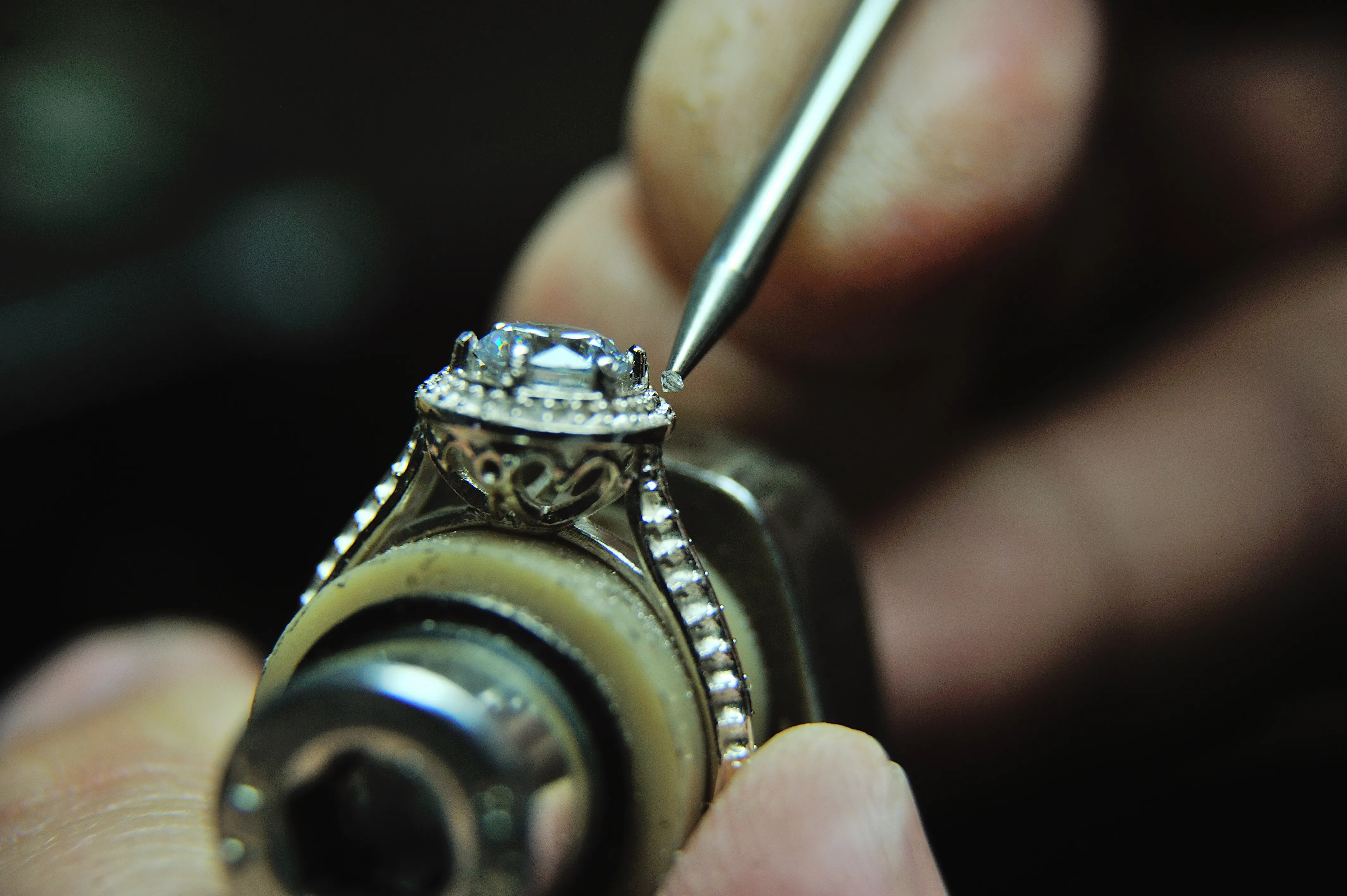 Jeweler carefully setting a gemstone into an ornate ring at Monarch Jewelry in Winter Park. Click to learn more!