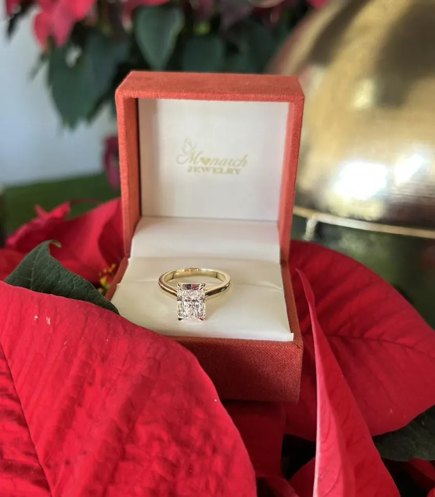 Engagement ring in a red box on festive red leaves, from Monarch Jewelry in Winter Park.