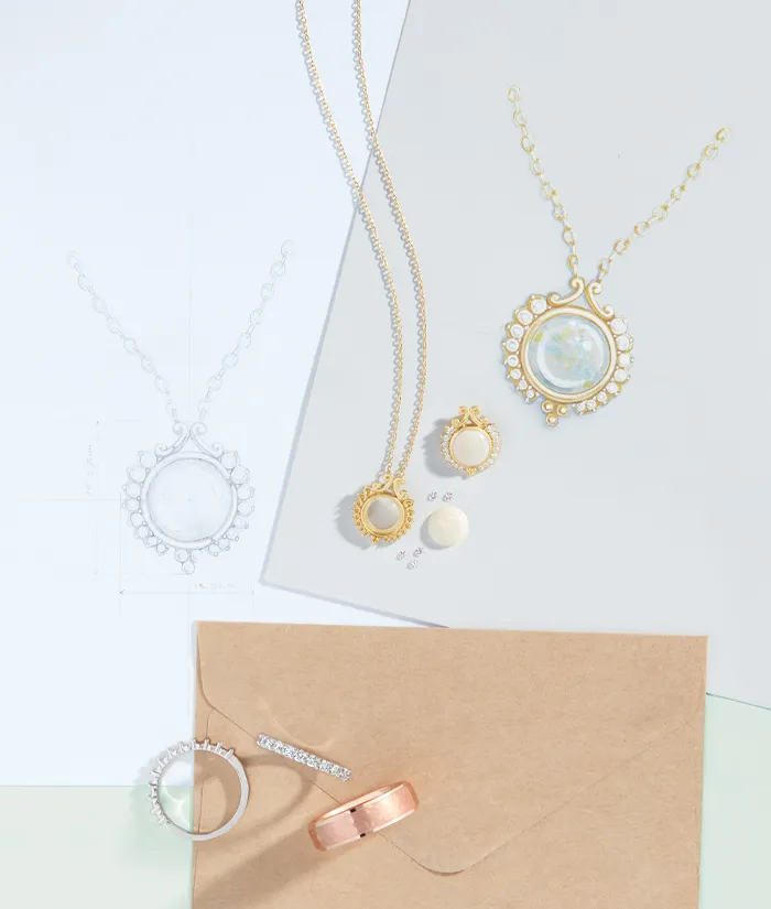 Elegant jewelry display featuring necklaces, rings, and earrings on a light background. Visit Monarch Jewelry in Winter Park.