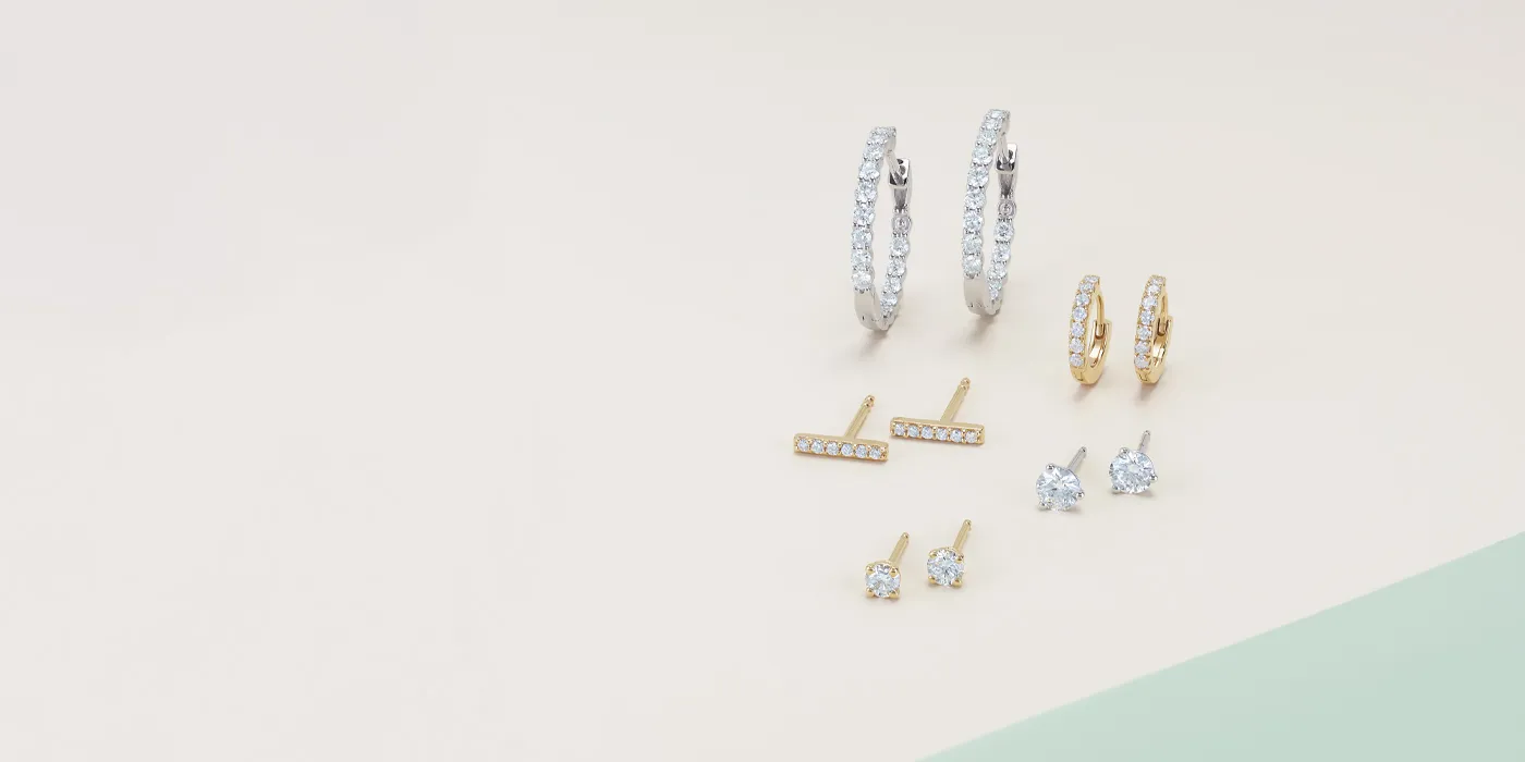 Stylish collection of gold and silver earrings, including hoops and studs. Click to shop designer jewelry at Monarch Jewelry.