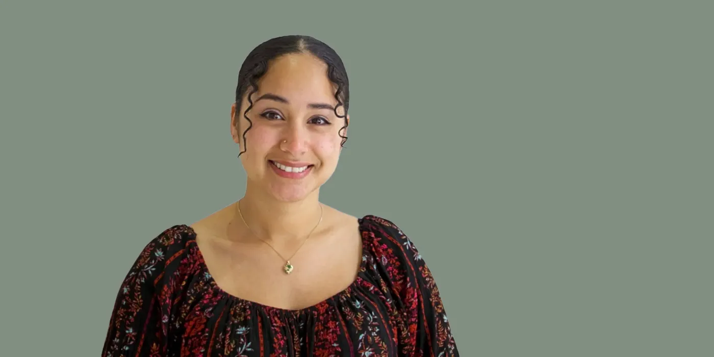 Headshot of Beija Mosqueda on a green background
