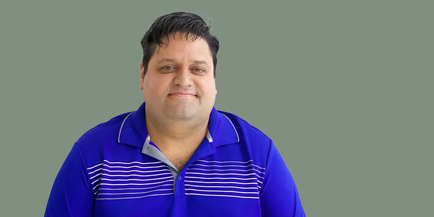 Headshot of Ismar Lorenzo on a green background