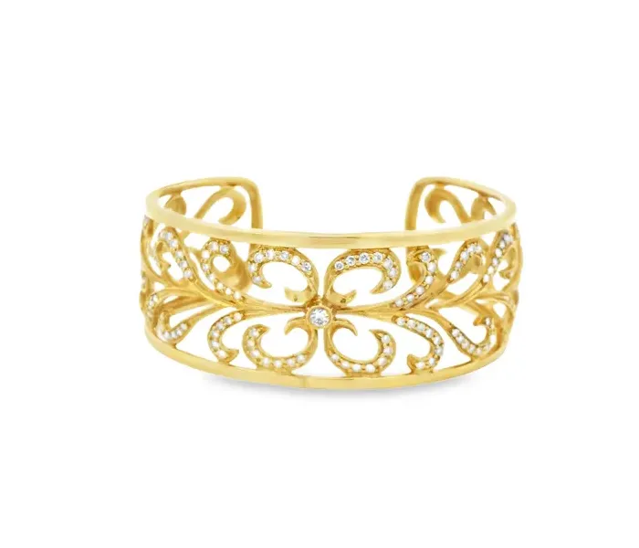 Gold cuff bracelet with intricate floral design and sparkling accents.