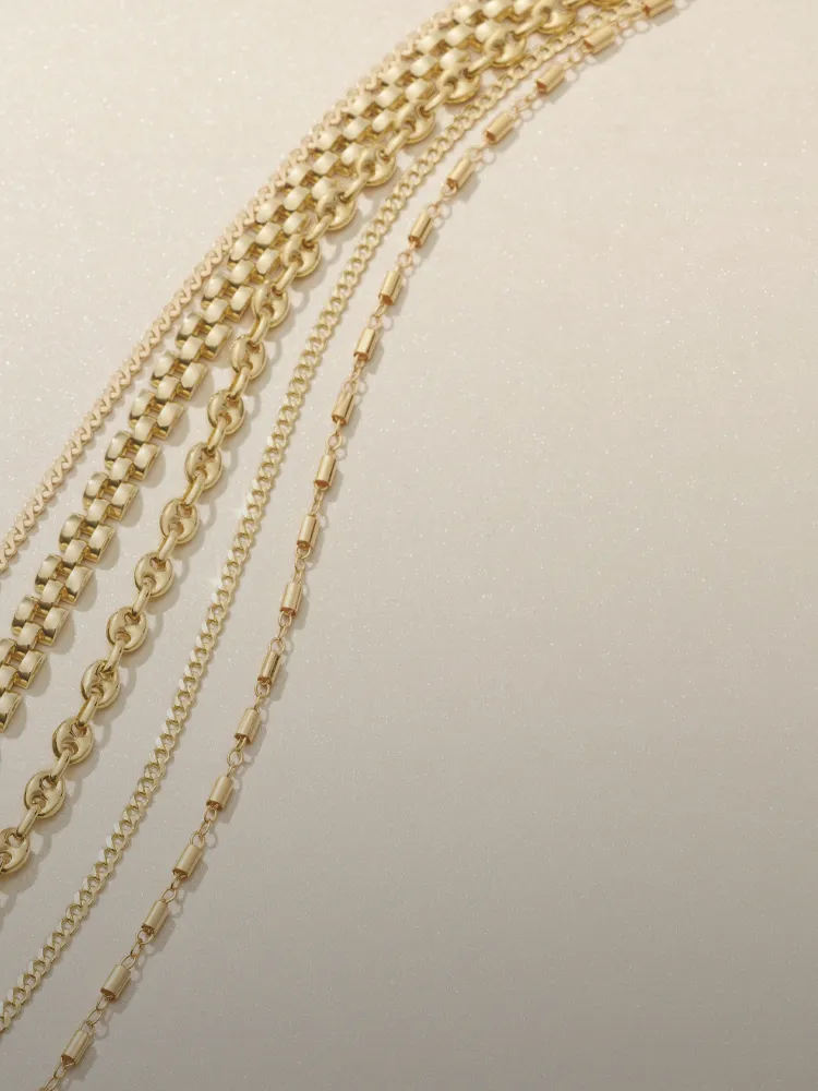 Gold chains of various styles displayed against a light background. Click to shop chains at Monarch Jewelry in Winter Park.