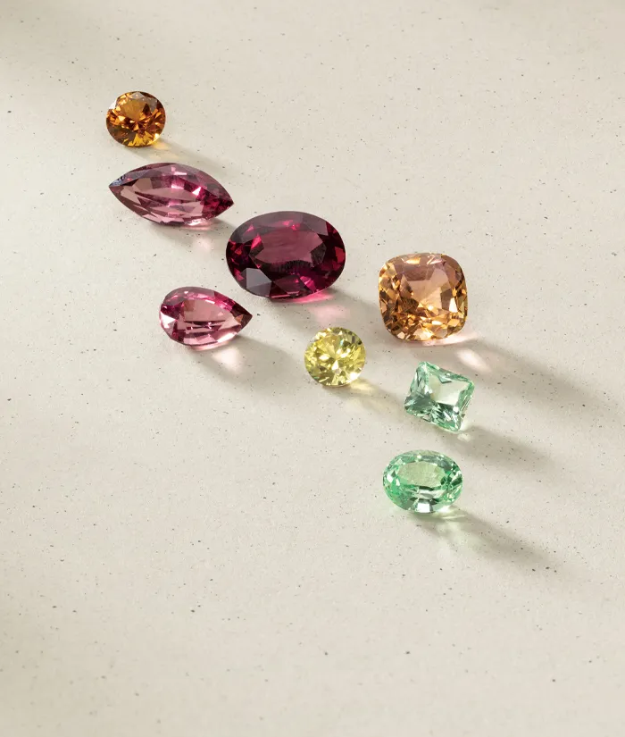 A collection of colorful gemstones spread out on a light surface.