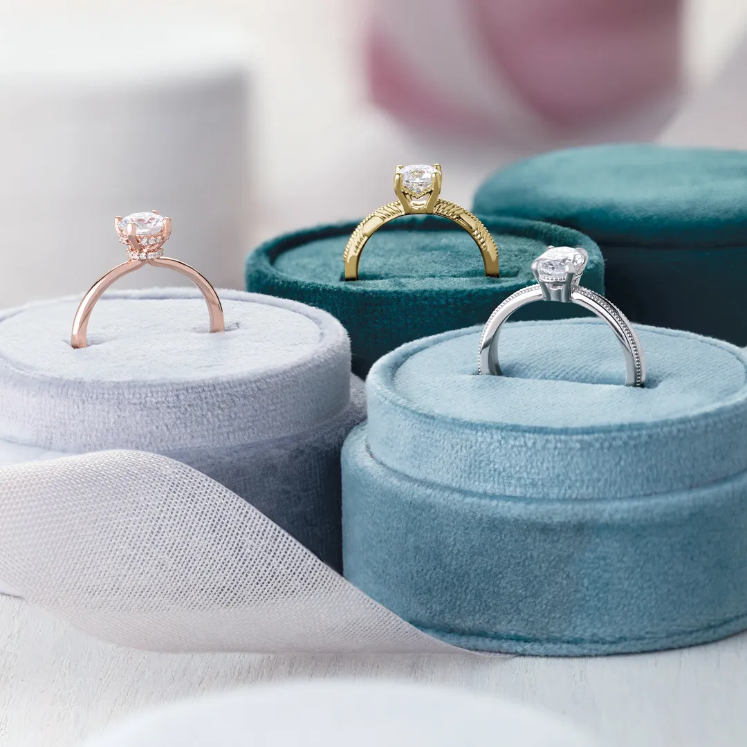 Rose gold, yellow gold and white gold diamond engagement rings in velvet ring boxes at Morin Jewelers, Southbridge, MA