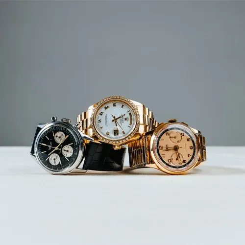 A vintage chronograph, a diamond-bezel gold Rolex Day-Date and a rose-gold watch