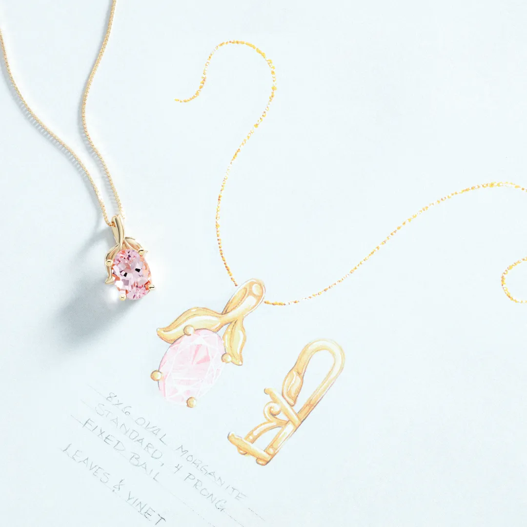 A custom gold and morganite pendant resting on the annotated design drawing it was made from at Morin Jewelers