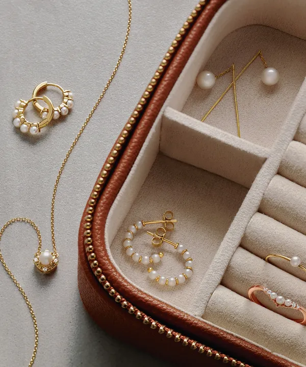 Pearl and gold jewelry in an open jewelry box