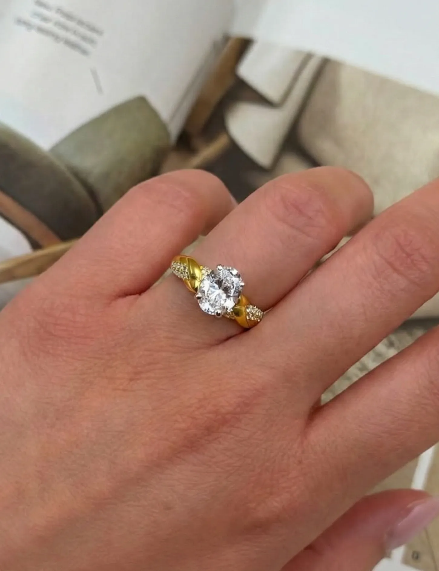 Elegant diamond stud earrings with a circular design, featuring a central stone surrounded by smaller diamonds.