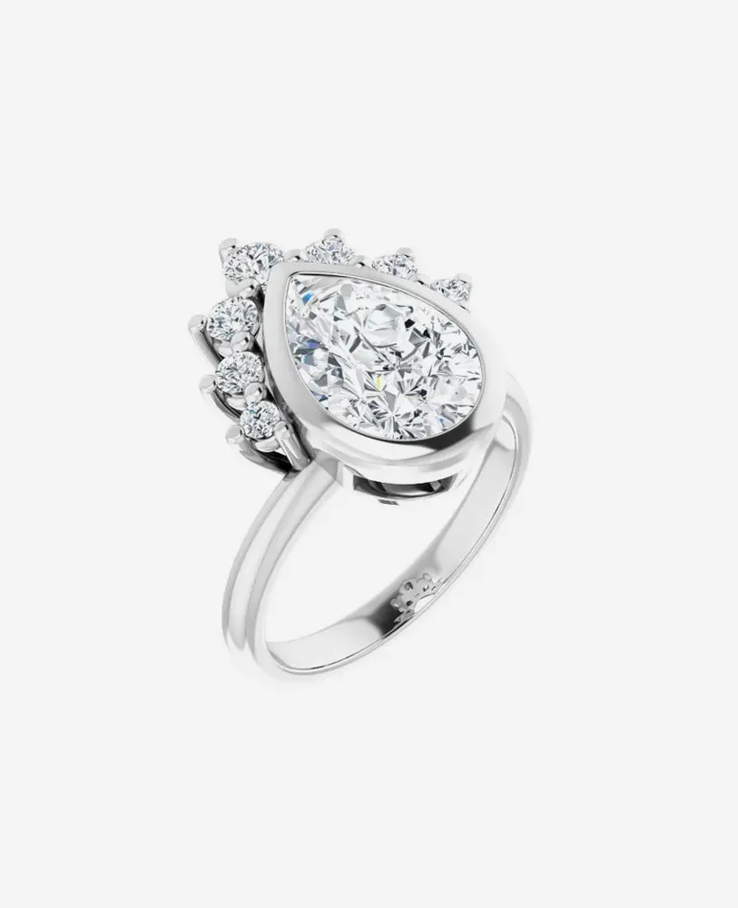Elegant pear-shaped diamond ring with smaller diamonds, set in white gold. Perfect for engagement or special occasions.