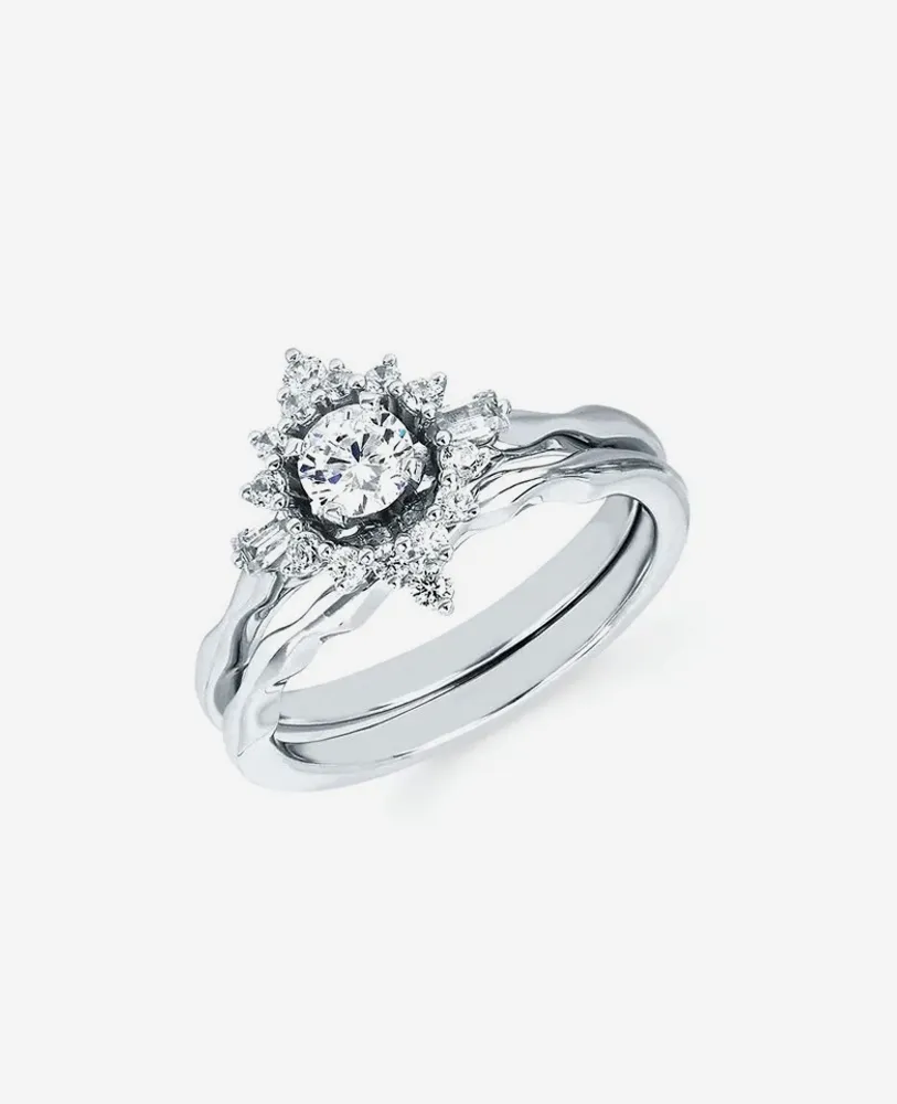 Elegant diamond engagement ring set with a central stone and intricate detailing.