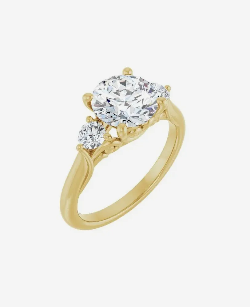 Gold engagement ring with a large center diamond and two smaller side diamonds.