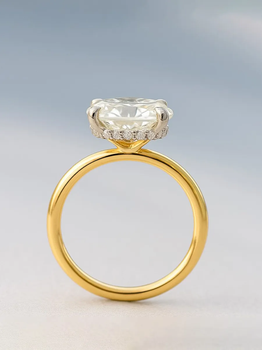 Elegant gold engagement ring with a large clear diamond centerpiece and smaller diamonds on the band. 