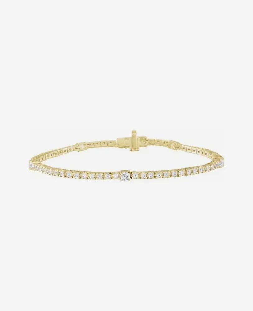 Elegant gold bracelet with sparkling diamonds, perfect for any occasion.