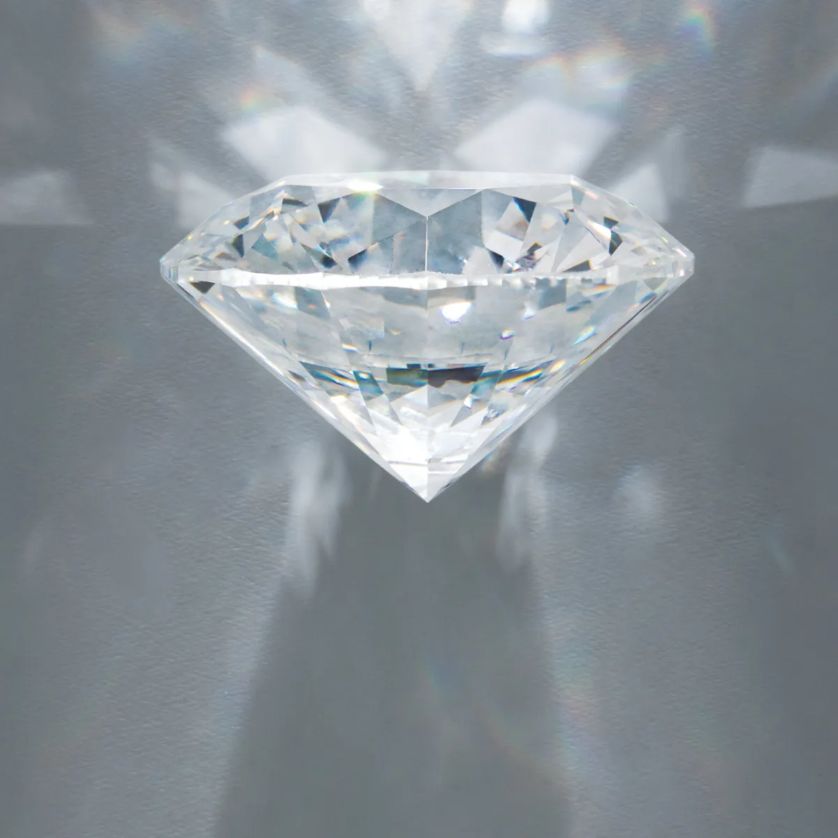 Brilliant diamond on a gray background, showcasing its clarity and sparkle.