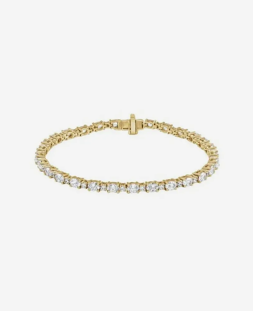 Gold tennis bracelet with sparkling diamonds.