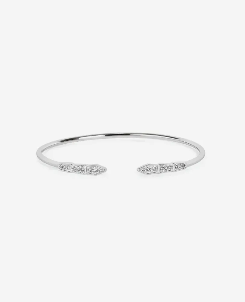 Silver cuff bracelet with pointed ends and diamond accents, showcasing elegant design. Visit Nelson Jewelry, Ltd. for more.