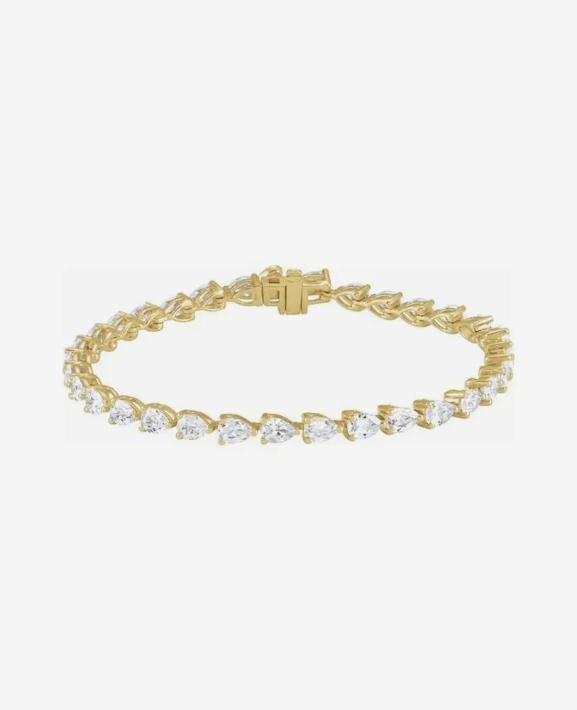 Gold bracelet with pear-shaped diamonds, elegant design.