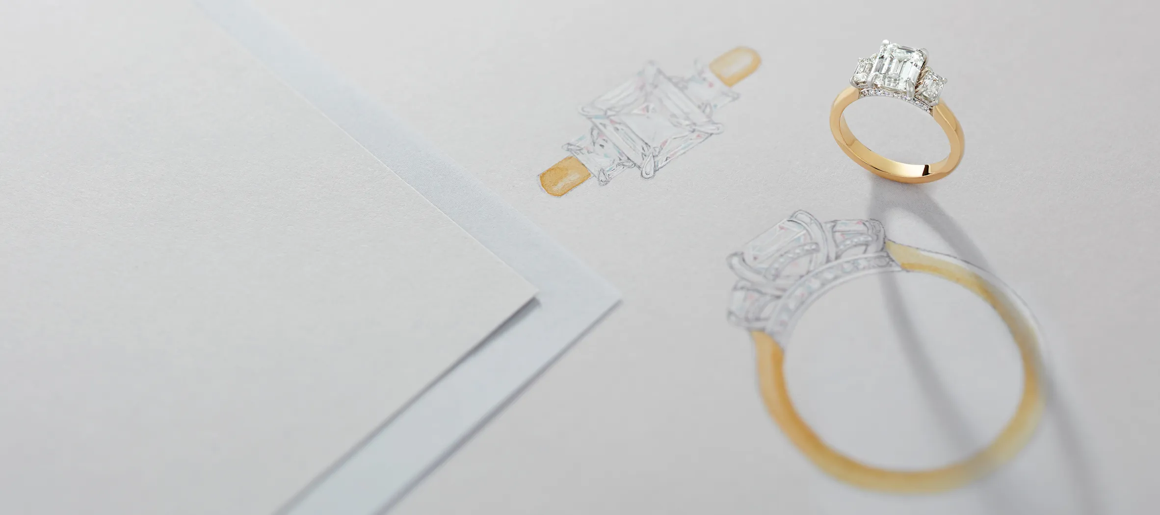 Sketches of engagement rings with a gold ring featuring an emerald-cut diamond.