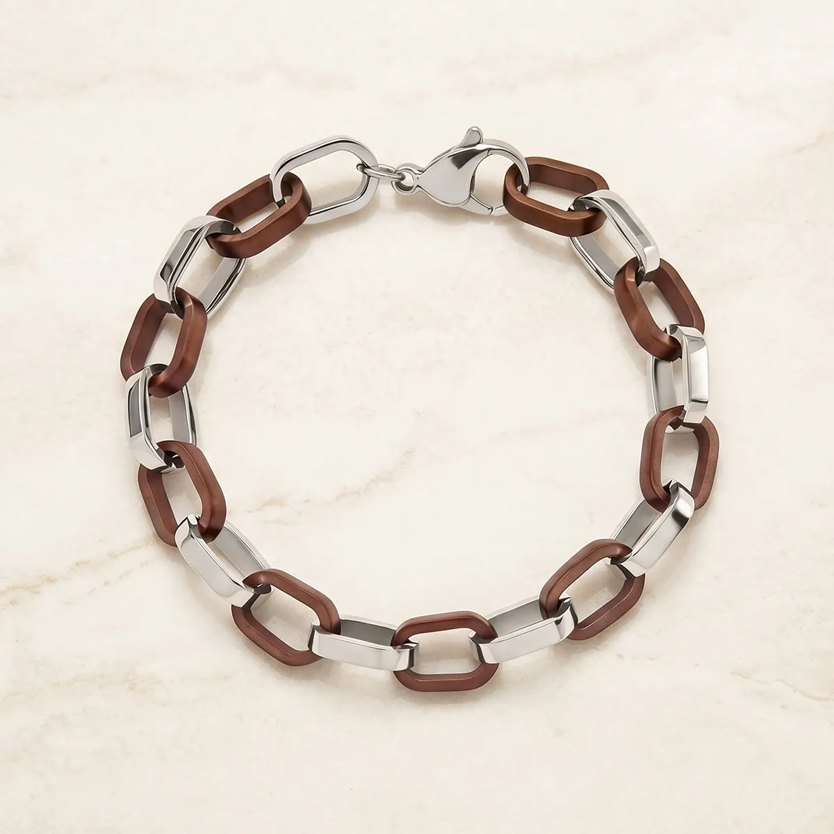 Men's bracelet with brown and silver links on a marble surface.