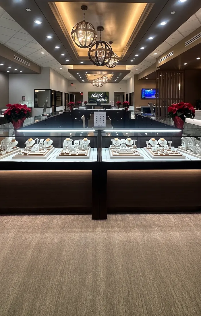 Elegant interior of Pearce Jewelers, West Lebanon, showcasing fine jewelry displays and modern lighting.