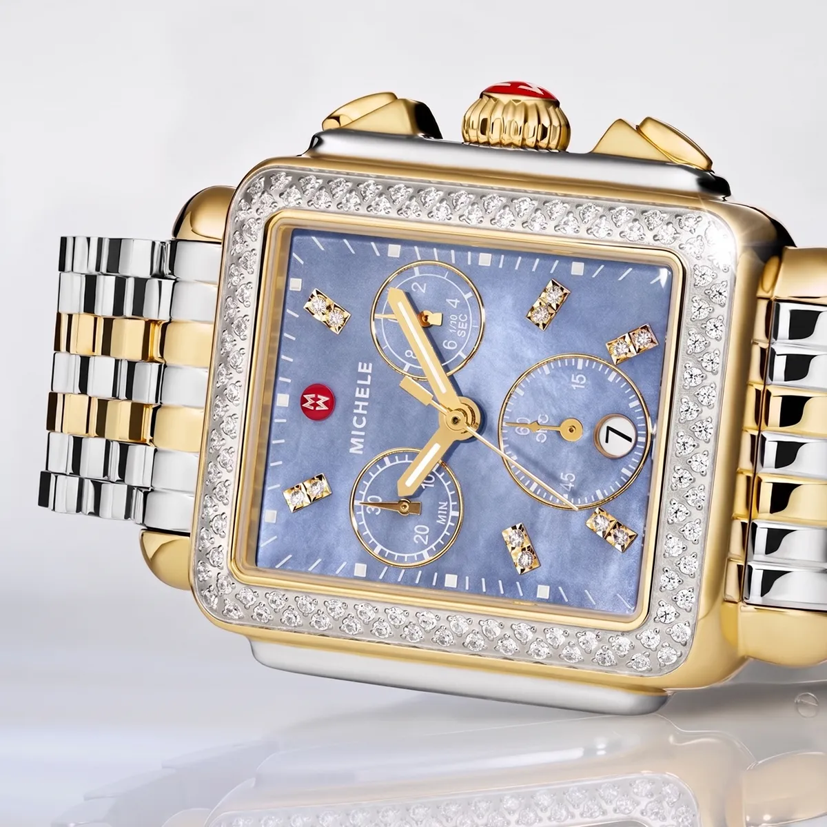 Luxury gold and silver watch with diamond accents and blue face.