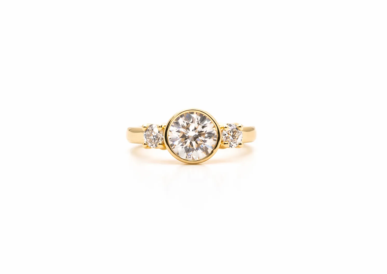 Diamond ring with a large central stone and two smaller side stones on a white background.