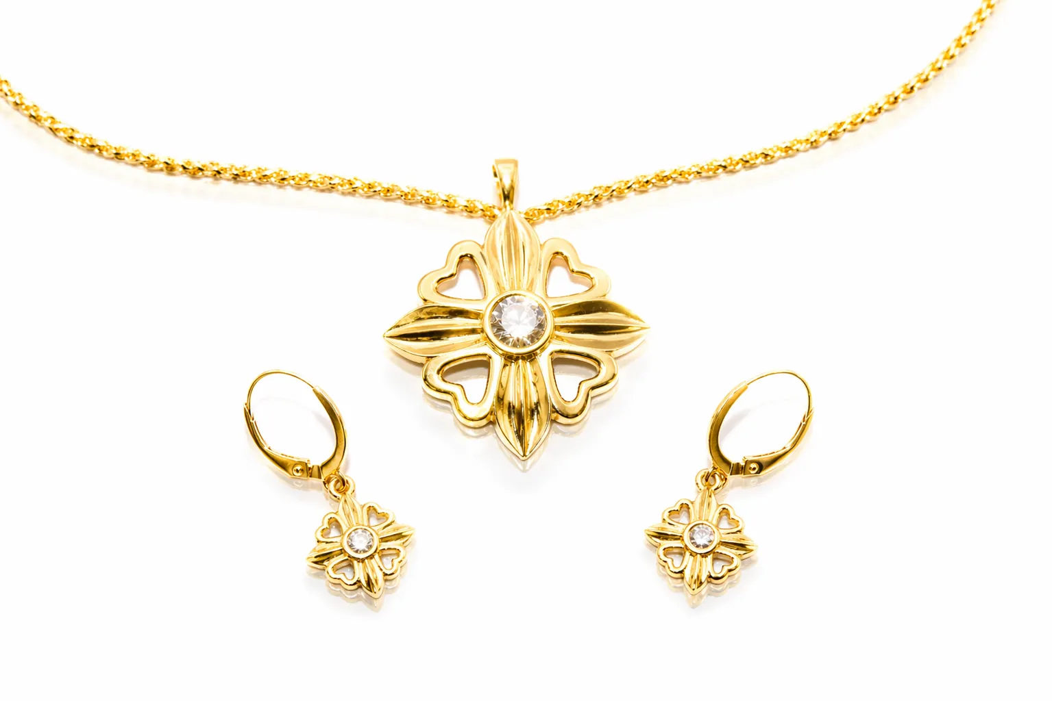 Gold necklace and earrings set featuring a floral design with a central stone. Shop at Perry's Emporium for fine jewelry.