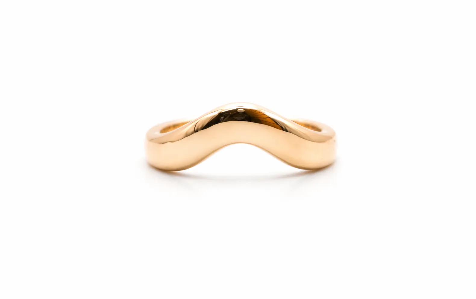 Gold wave-shaped ring displayed on a white background. Visit Perry's Emporium for fine jewelry and engagement rings.