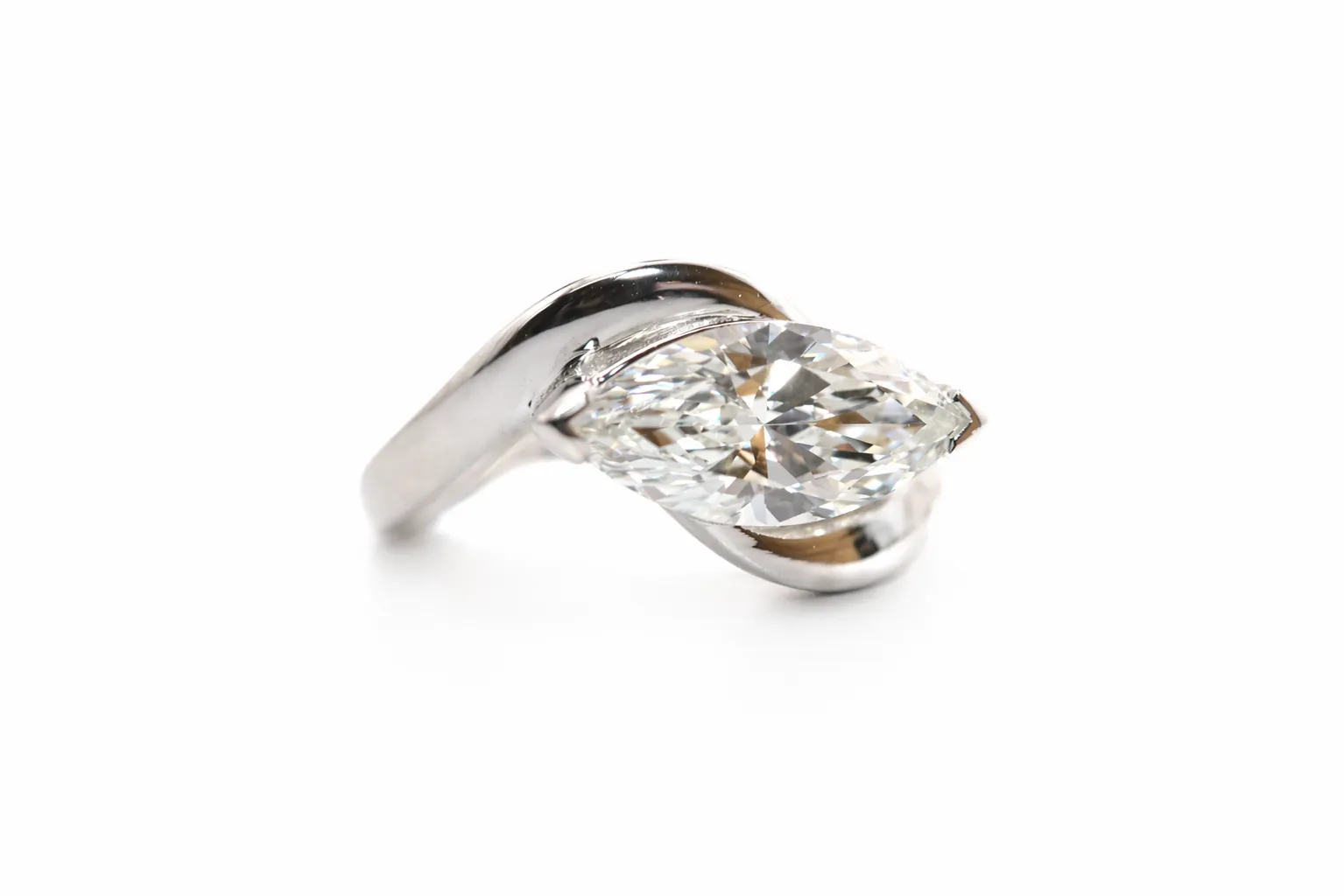 Elegant silver ring featuring a marquise-cut diamond, showcasing a unique twisted design. Visit Perry's Emporium for more!