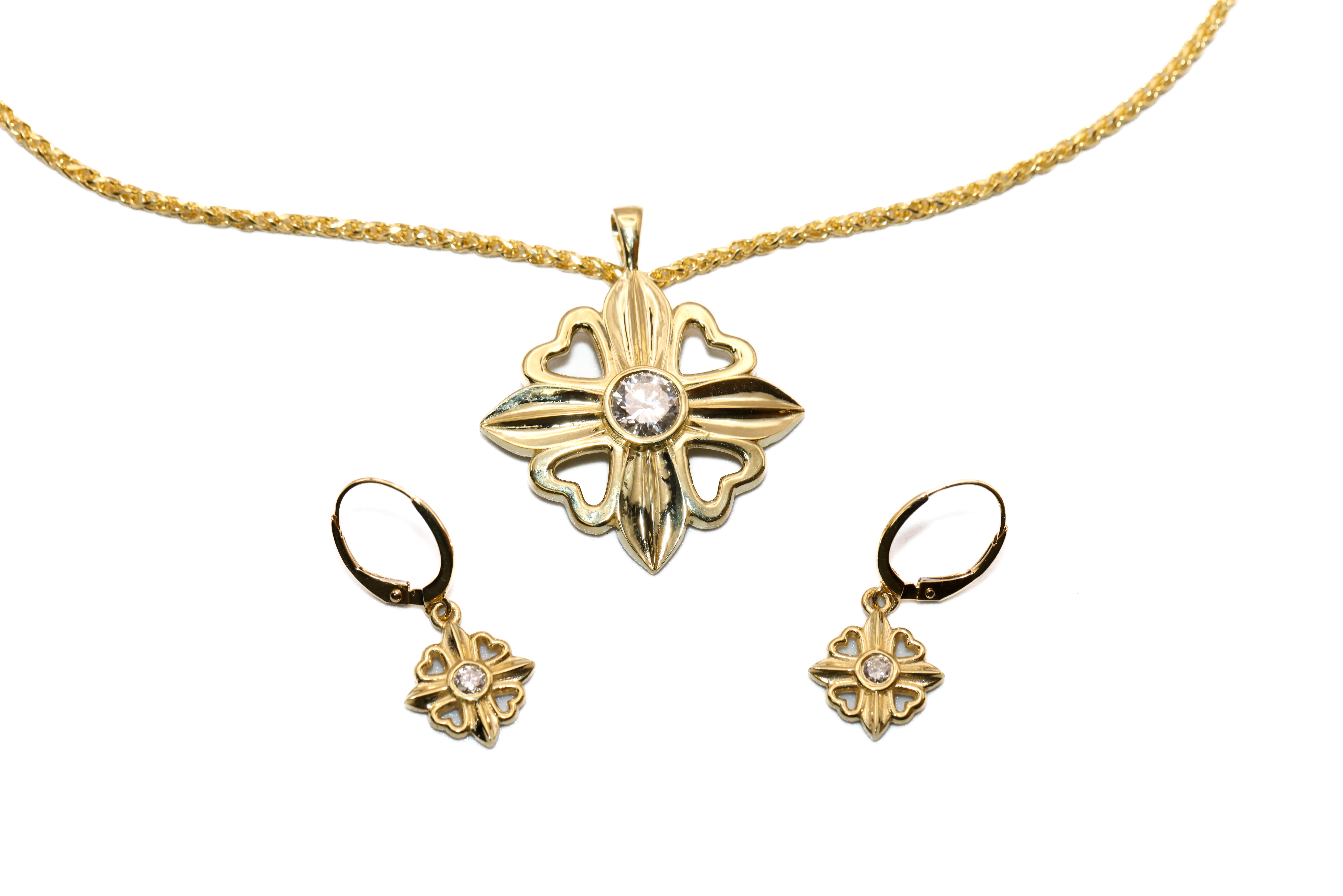 Gold necklace and earrings set featuring a floral design with a central stone. Shop at Perry's Emporium for fine jewelry.