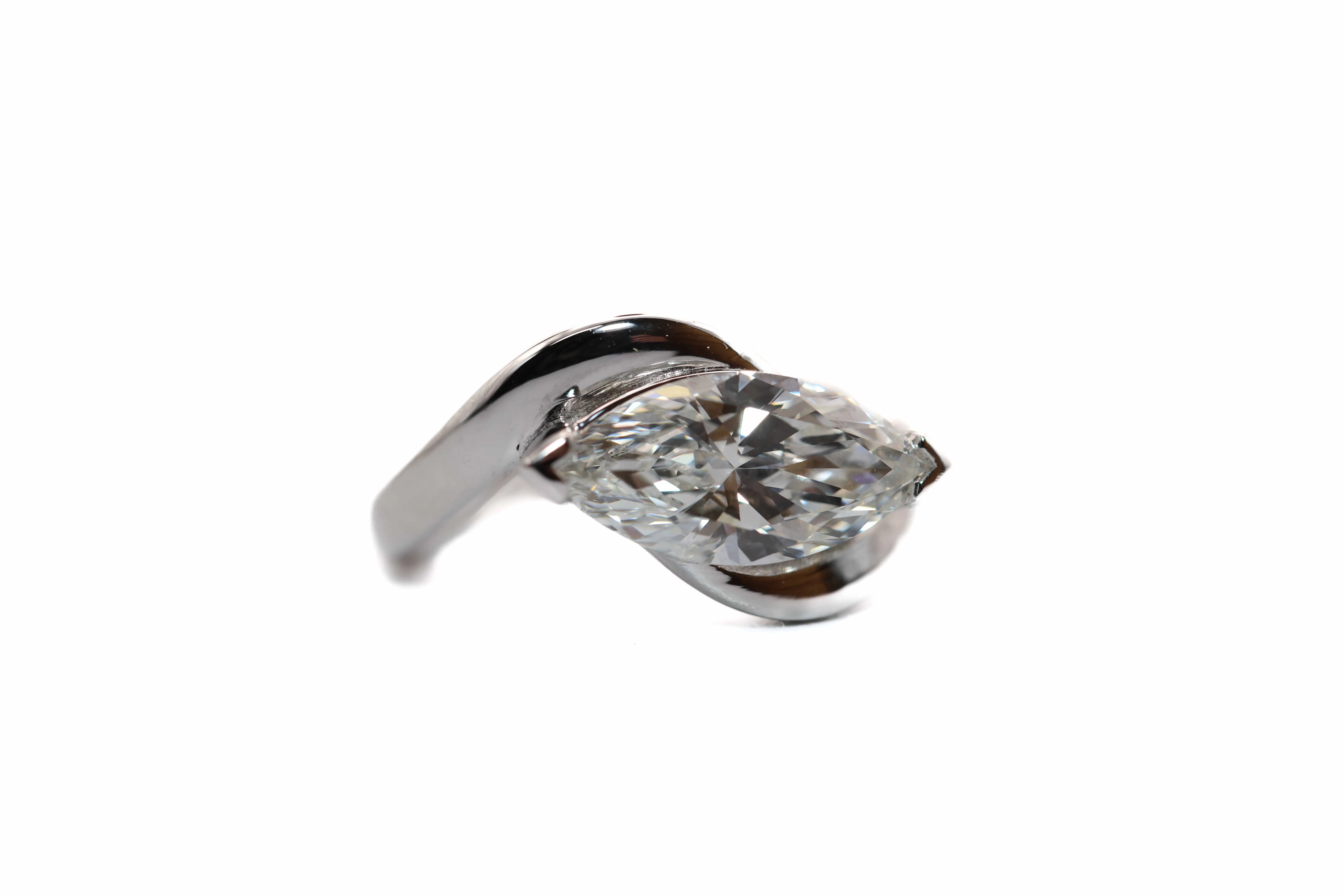Elegant silver ring featuring a marquise-cut diamond, showcasing a unique twisted design. Visit Perry's Emporium for more!
