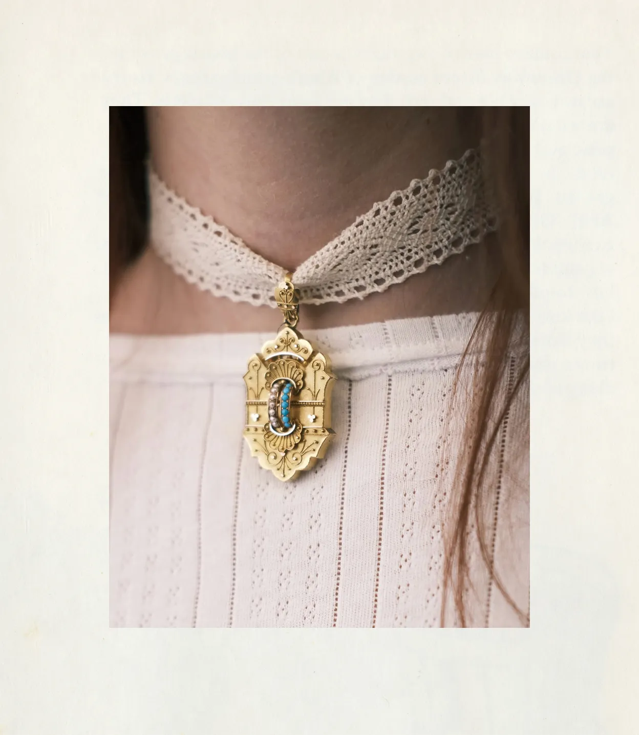 A lace choker with an ornate gold pendant featuring turquoise and pearl details.
