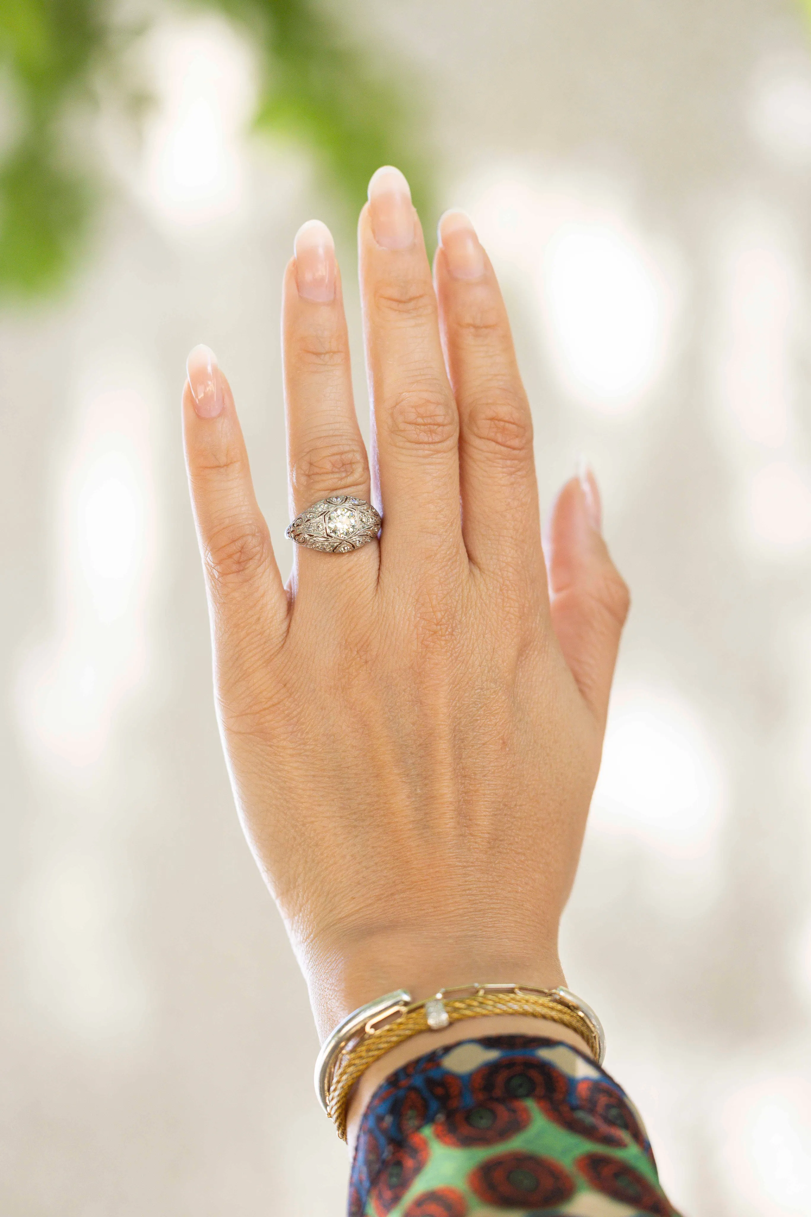 Estate diamond ring worn with gold bangles
