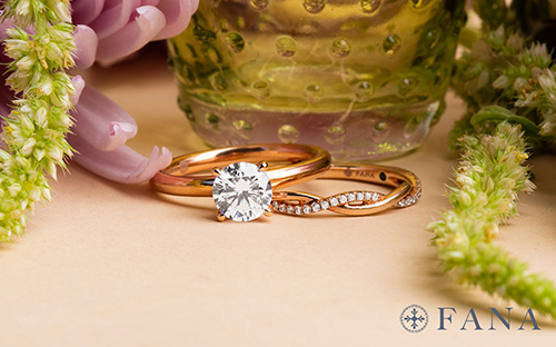 Fana engagement band and wedding band surrounded by glass vase and flowers