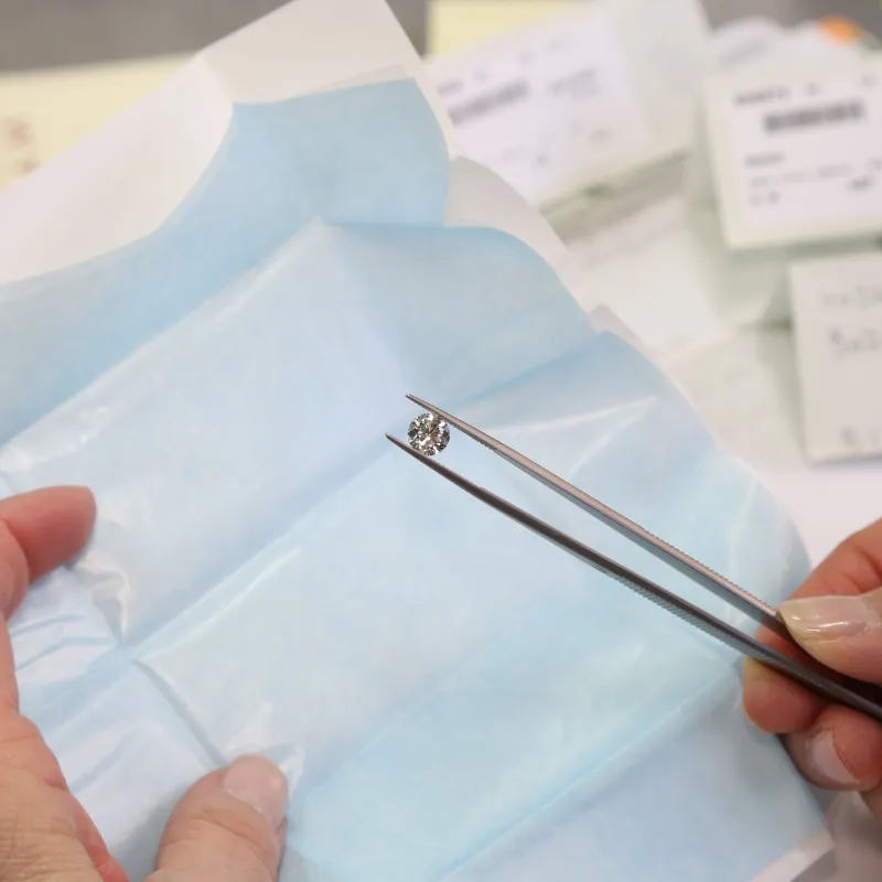 Jeweler holding a large diamond in tweezers