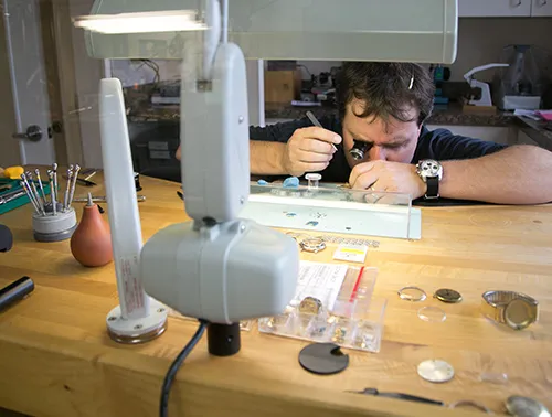 Jeweler Working on Watches at Table