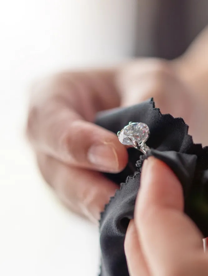 Jeweler polishing diamond wedding ring 