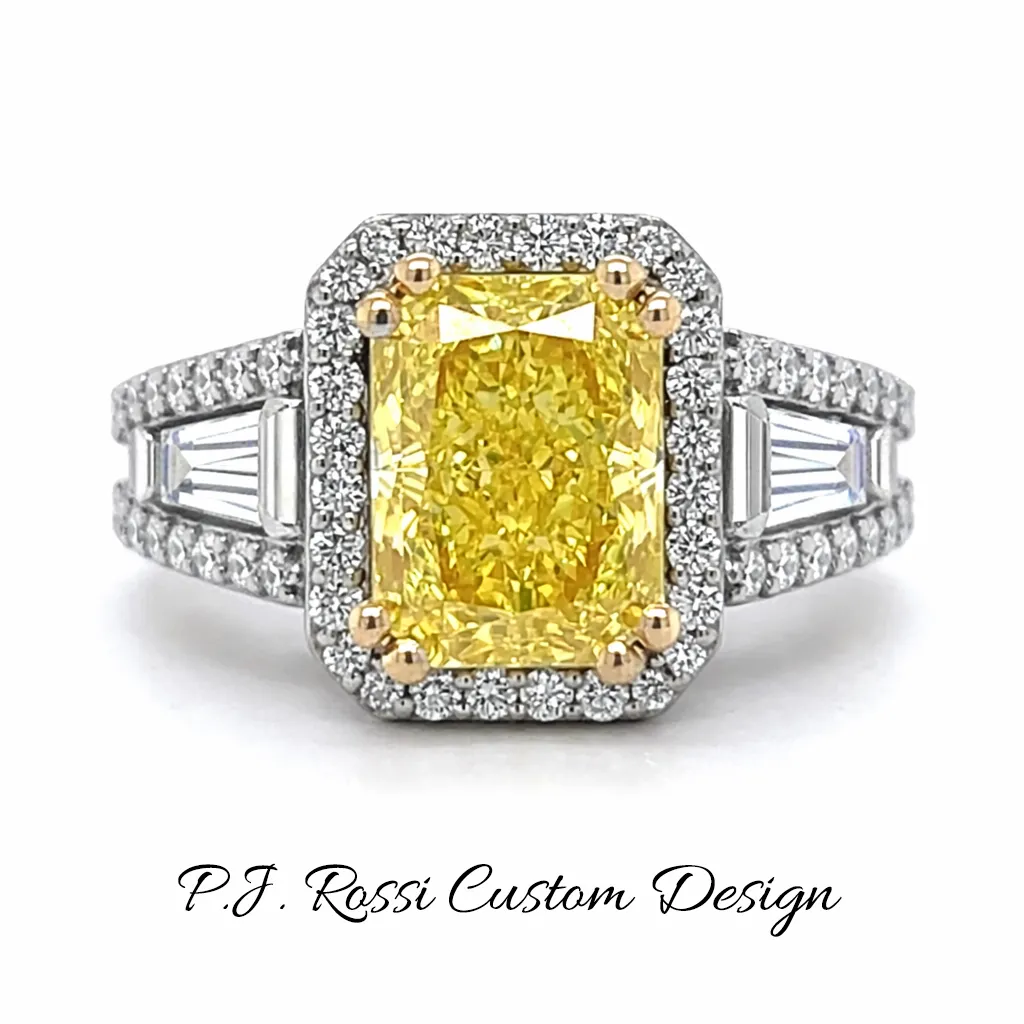 Hand with diamond rings near white flowers. Explore P.J. Rossi Jewelers' Engagement rings.