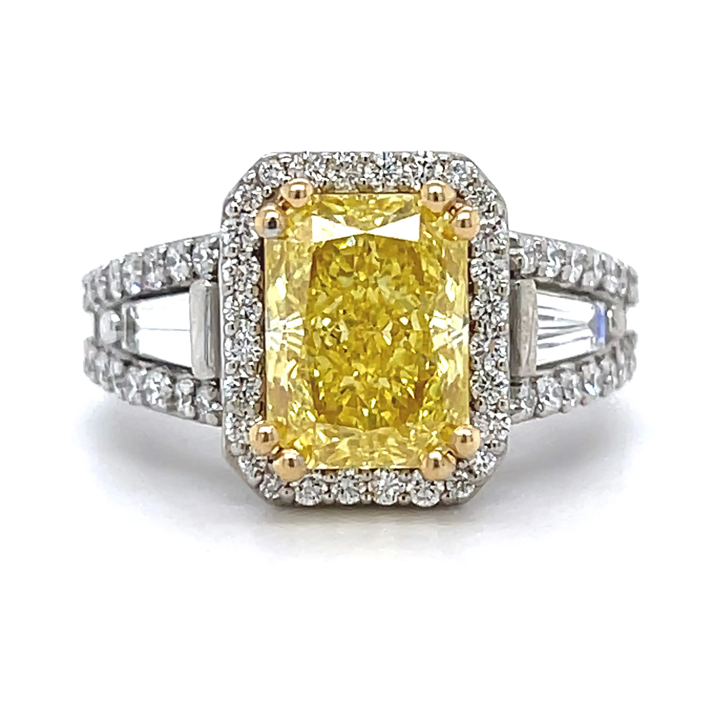 Elegant fancy yellow diamond engagement ring with a halo of smaller diamonds, set in a white gold band. Click to see more custom