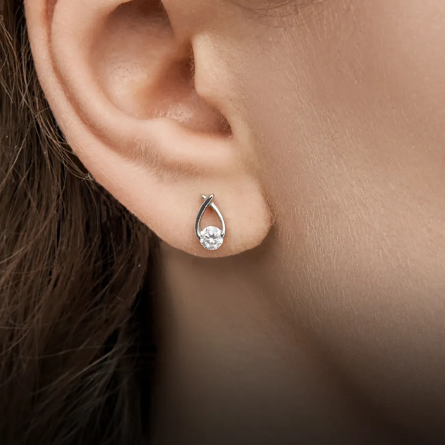 Diamond stud earring on ear. Click to shop now.