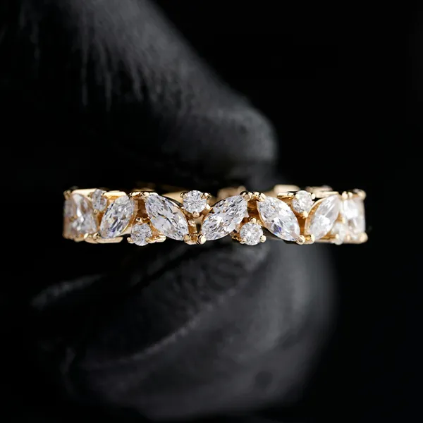 Elegant yellow gold ring with alternating prong-set marquise and round diamonds.