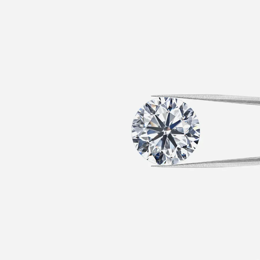 Round earth-mined diamond held by tweezers, showcasing its brilliance. 