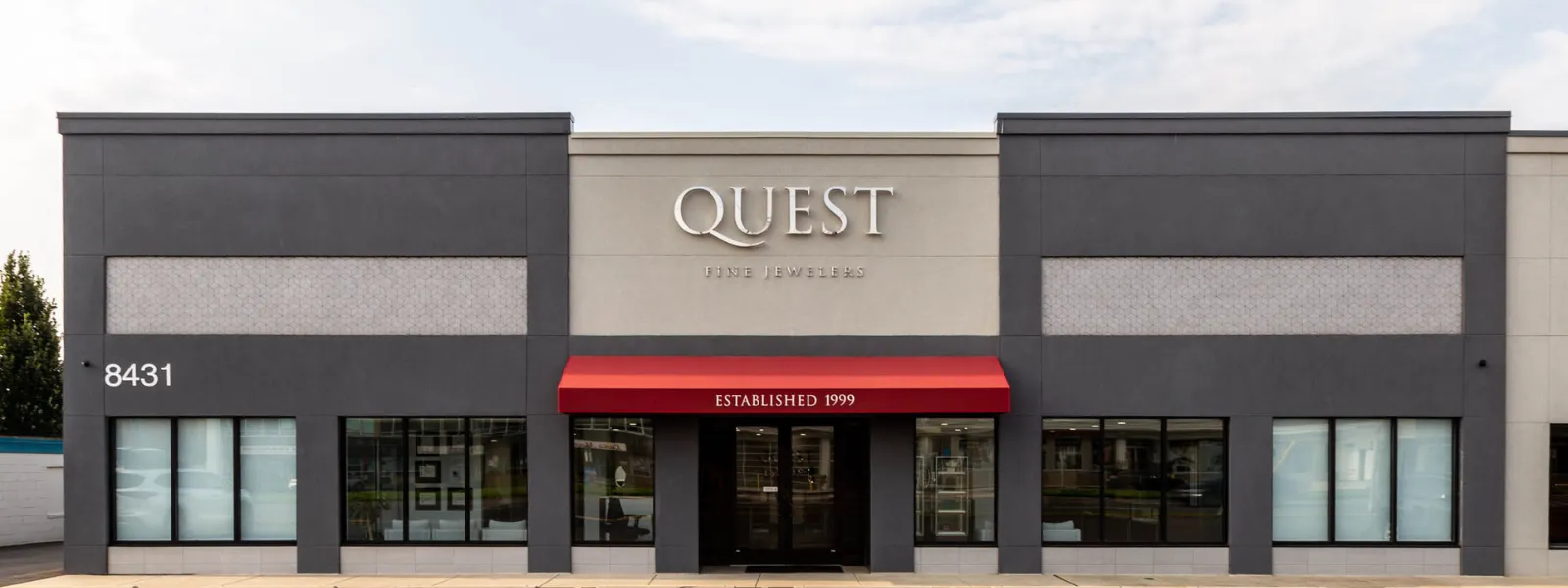 Exterior of Quest Fine Jewelers store in Fairfax, featuring a red awning and established date of 1999. Click to learn more.