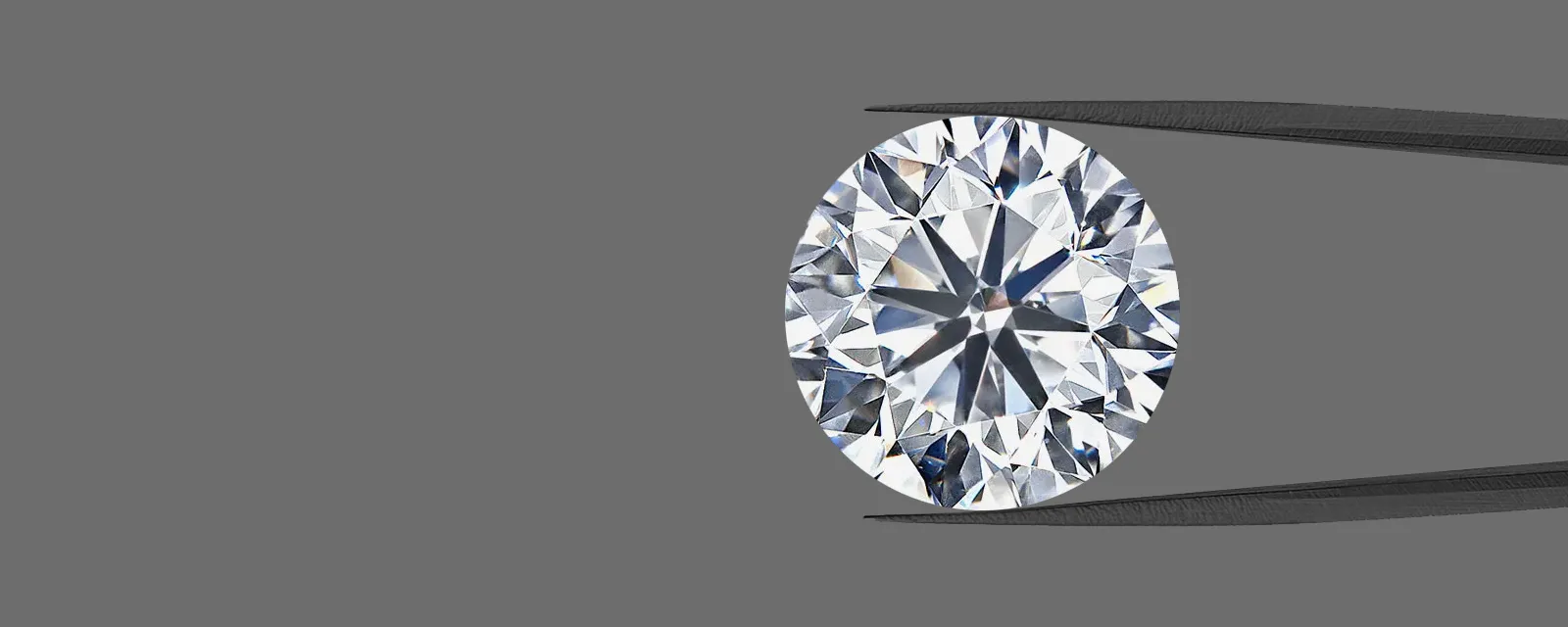 Close-up of a sparkling oval lab-grown diamond held by tweezers. Click to view lab-grown diamonds at Quest Fine Jewelers.
